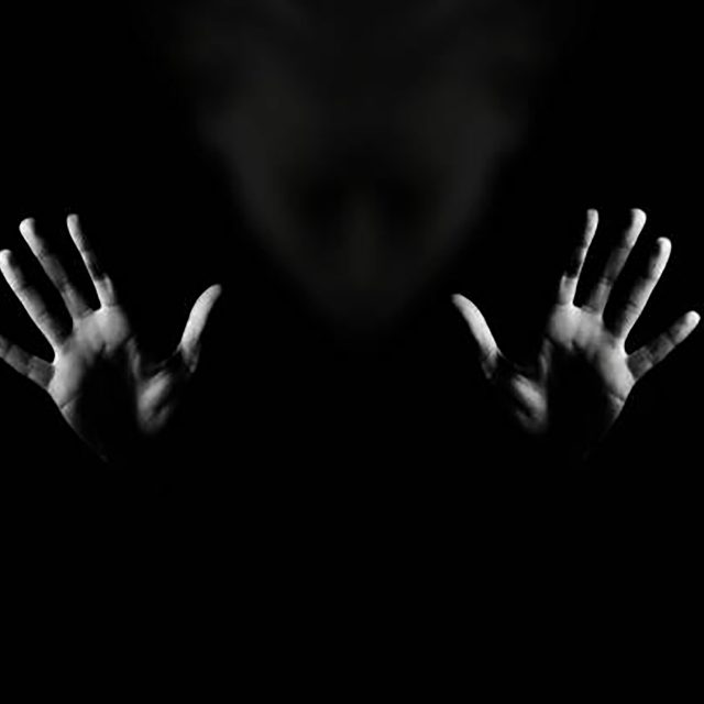 Horror Background. Gesture Stop. Black And White Studio Shot.