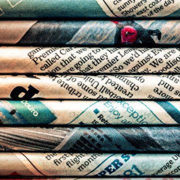 Macro Abstract Image Depicting Rolled Sheets Of Newspaper.
