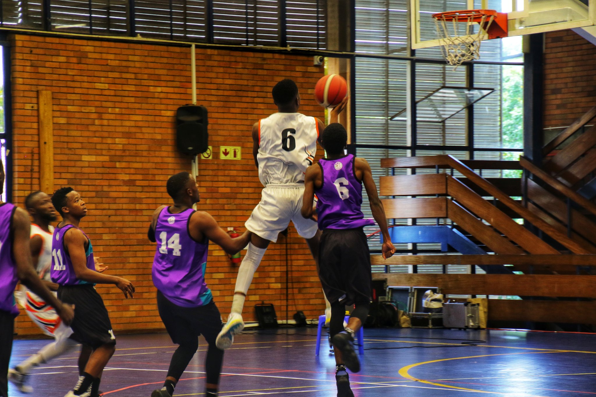 UJ's Gloire Kabenge slots in a 2-point goal against North West University in the 2022 USSA 5x5 Basketball championship at Wits Old Mutual Hall in Johannesburg