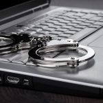 Handcuffs On Laptop Cyber Crime Concept