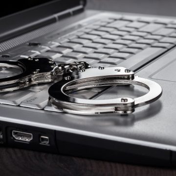 Handcuffs On Laptop Cyber Crime Concept
